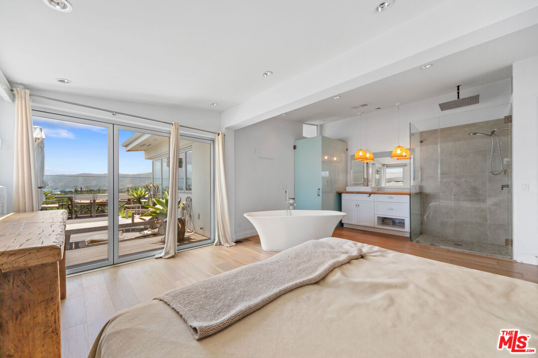 29500 Heathercliff Road, Unit 184 Malibu, CA 90265 - Photo 13 of 46 a bedroom with a large bed and a couch