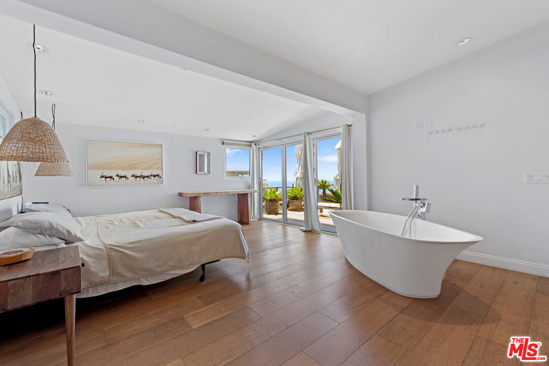 29500 Heathercliff Road, Unit 184 Malibu, CA 90265 - Photo 15 of 46 a spacious bedroom with a bed and a couch