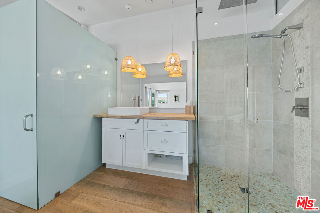 29500 Heathercliff Road, Unit 184 Malibu, CA 90265 - Photo 17 of 46 a bathroom with a sink and a mirror