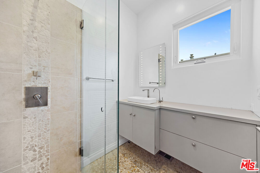 29500 Heathercliff Road, Unit 184 Malibu, CA 90265 - Photo 22 of 46 a bathroom with a sink and mirror