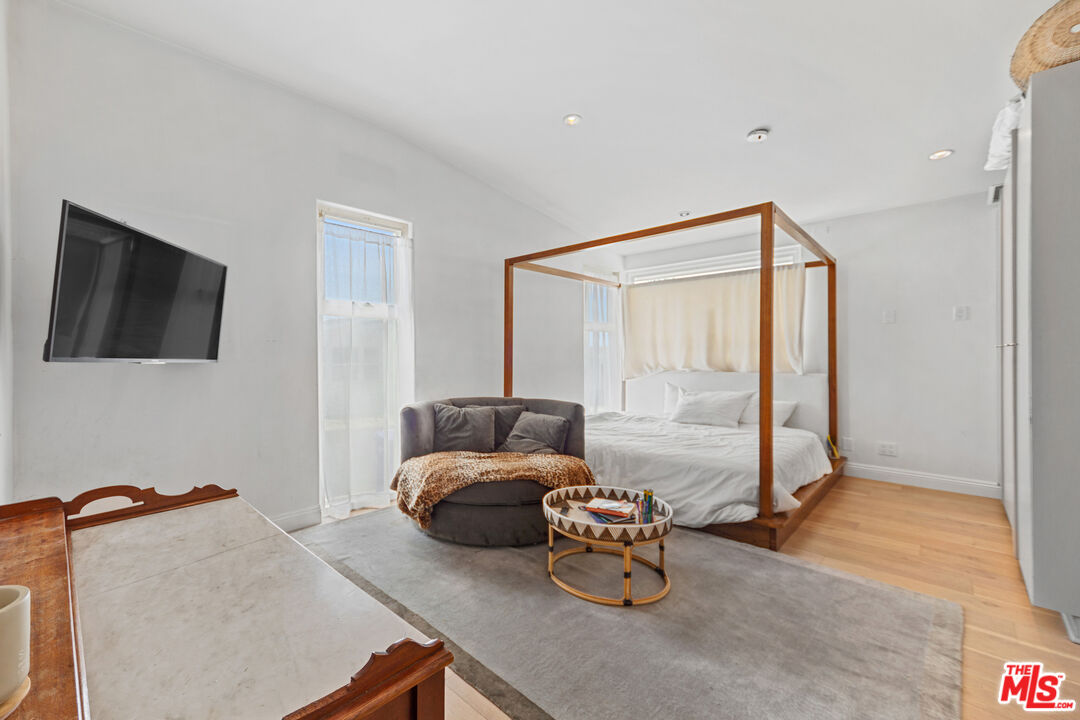 29500 Heathercliff Road, Unit 184 Malibu, CA 90265 - Photo 24 of 46 a bedroom with furniture and a flat screen tv