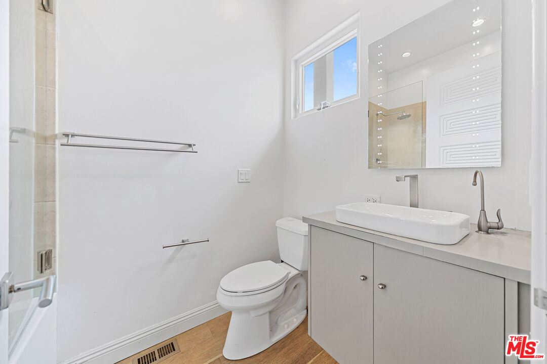 29500 Heathercliff Road, Unit 184 Malibu, CA 90265 - Photo 26 of 46 a bathroom with a sink toilet and vanity
