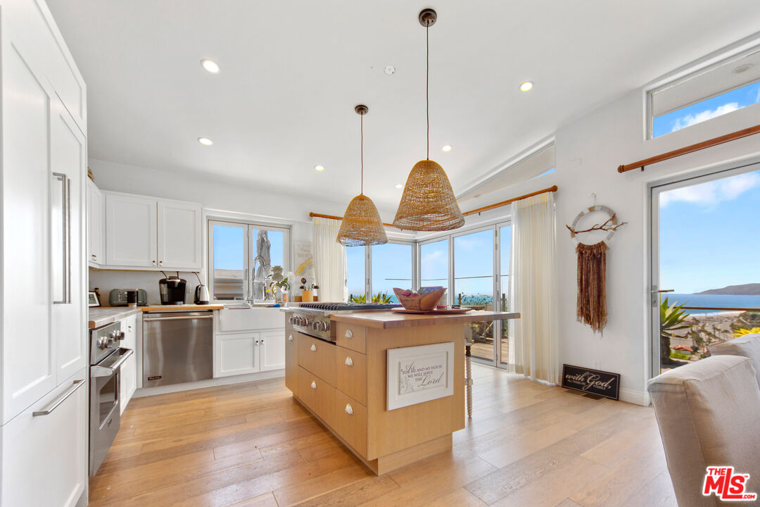 29500 Heathercliff Road, Unit 184 Malibu, CA 90265 - Photo 3 of 46 a kitchen with stainless steel appliances granite countertop a stove oven and a refrigerator
