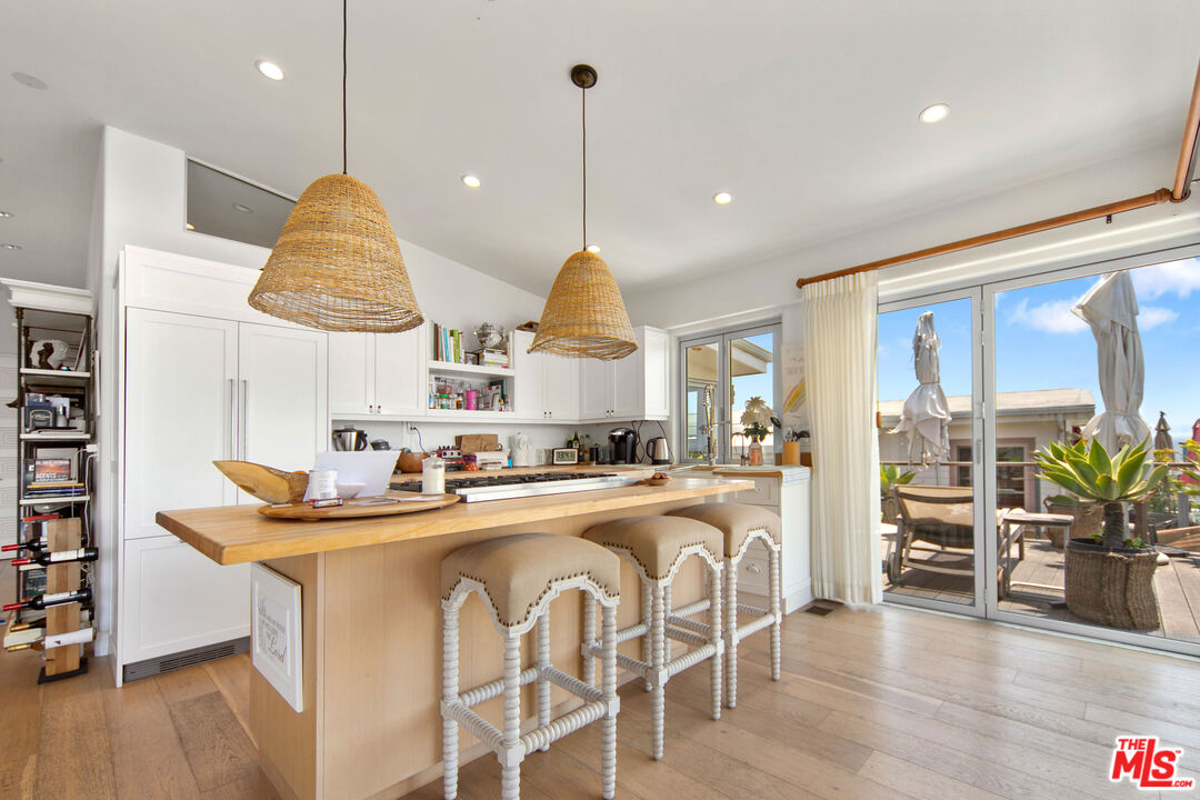 29500 Heathercliff Road, Unit 184 Malibu, CA 90265 - Photo 6 of 46 a dining table chairs and a chandelier