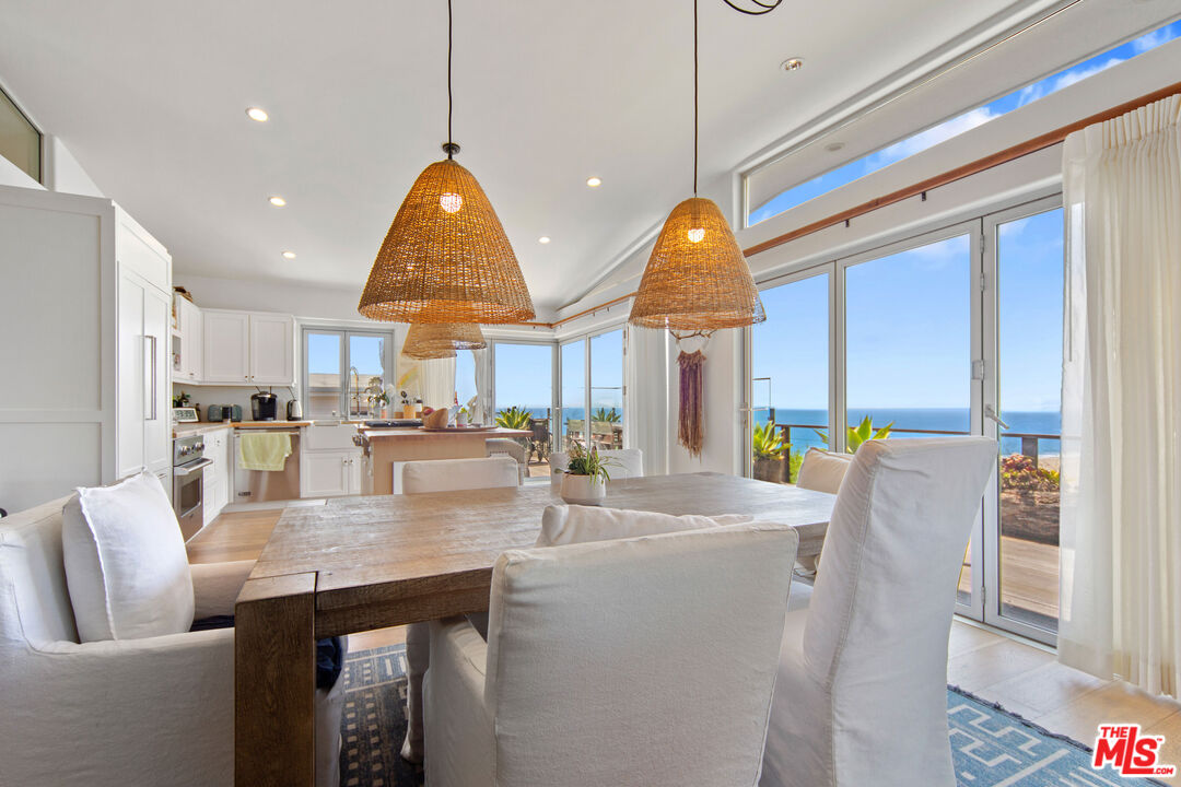 29500 Heathercliff Road, Unit 184 Malibu, CA 90265 - Photo 8 of 46 a very nice looking dining room with kitchen island stainless steel appliances furniture cabinets and a large window