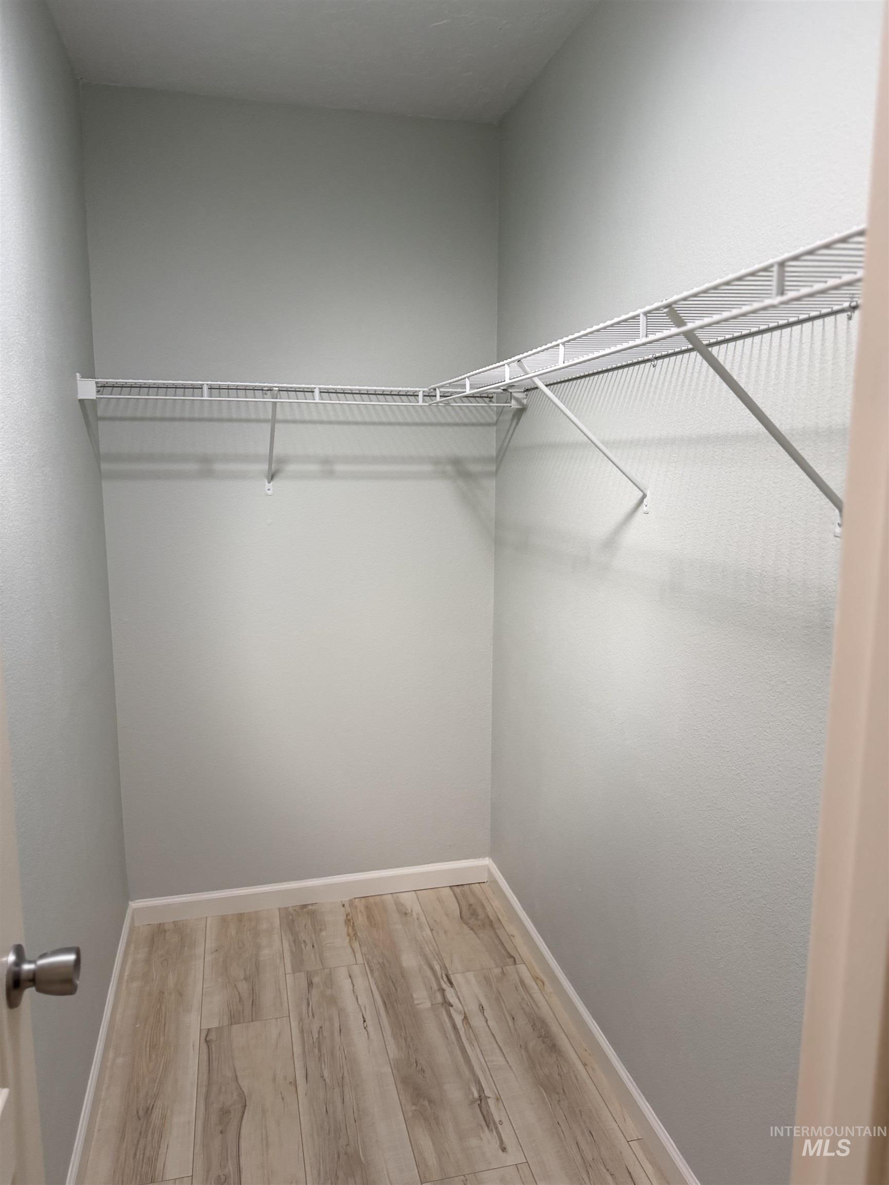 875 Eaton Road Weiser, ID 83672 - Photo 17 of 30 Walk-in closet featuring light wood-finish flooring, white wire shelving, and light-toned wall finishes