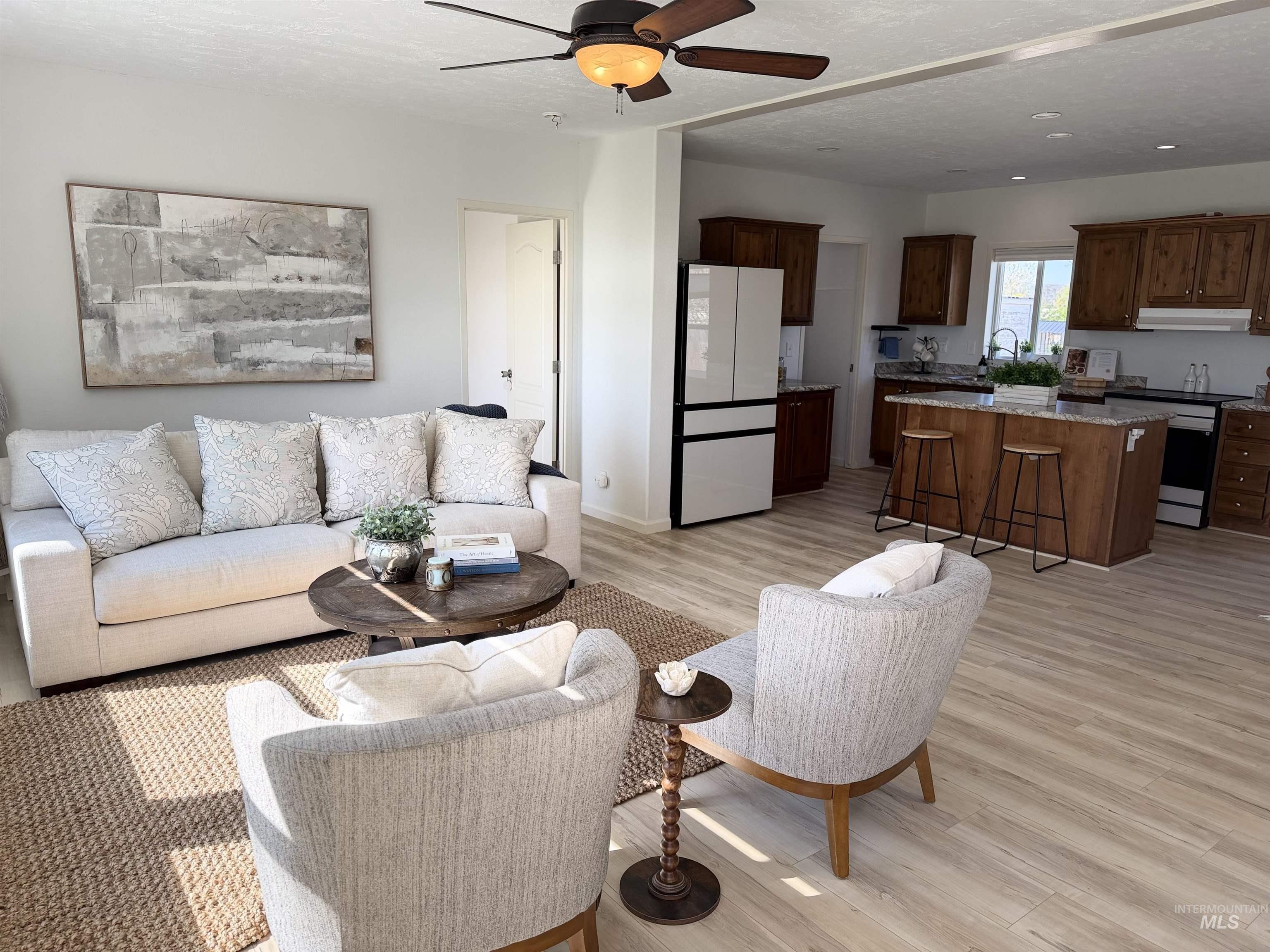 875 Eaton Road Weiser, ID 83672 - Photo 10 of 30 Open concept living area featuring light wood-finish flooring, a ceiling fan, and recessed lighting