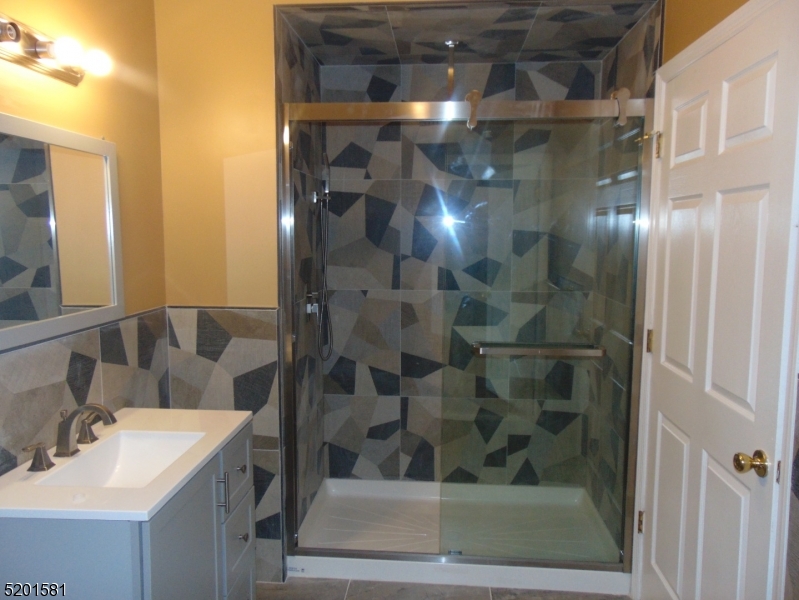 25 Cottage Street, Unit 1 Newark, NJ 07102 - Photo 6 of 9 a bathroom with a shower and a sink