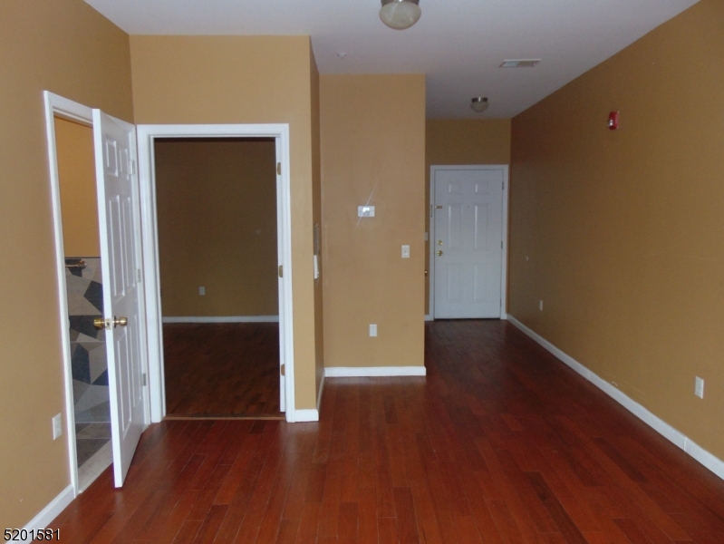 25 Cottage Street, Unit 1 Newark, NJ 07102 - Photo 7 of 9 a view of an empty room with wooden floor and closet