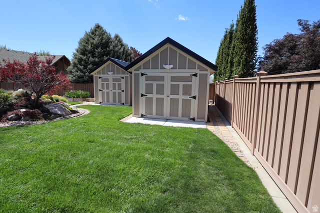 1055 North 1000 East Mapleton, UT 84664 - Photo 101 of 112 Expansive green lawn with two detached storage sheds featuring gambrel roofs
