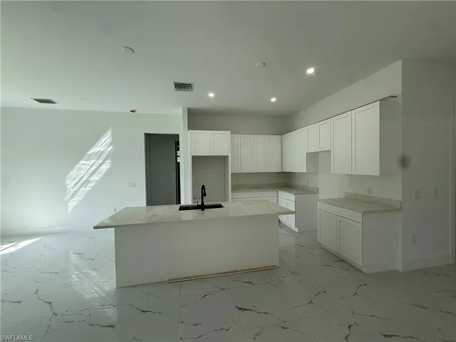 a view of a kitchen with white cabinets