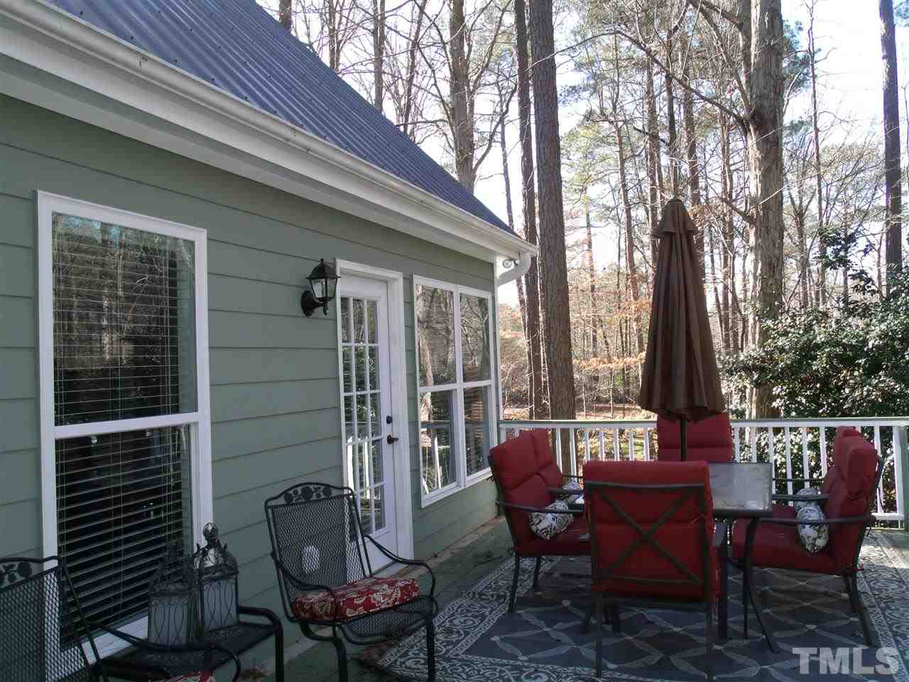 7908 Senter Farm Road Apex, NC 27539 - Photo 4 of 25 Backyard offers rear entry to home as well detached garage with room over garage. Private backyard and deck great for entertaining. MB offers door to deck