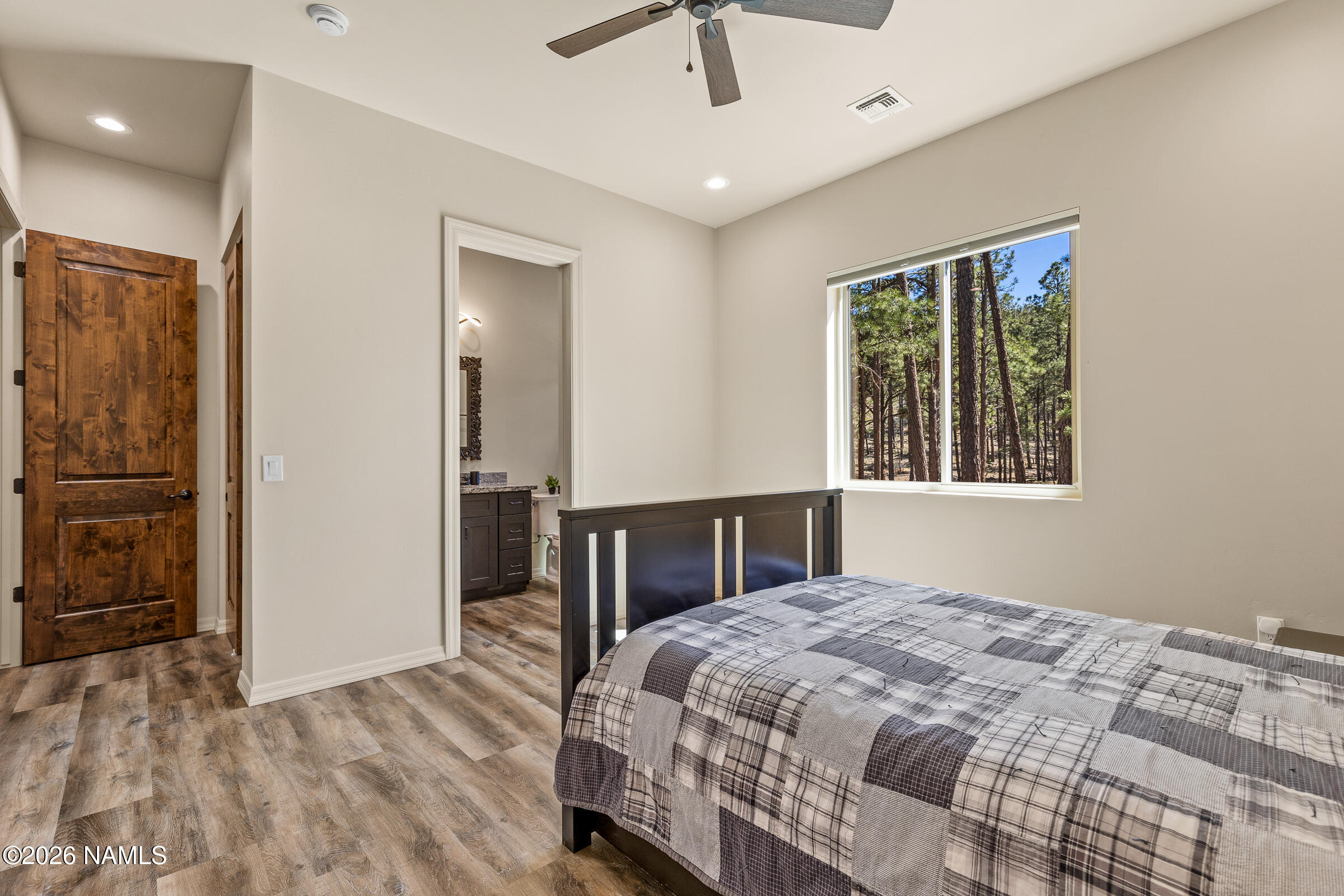 1093 Redwall Way Williams, AZ 86046 - Photo 27 of 70 a bedroom with a large bed and a chandelier