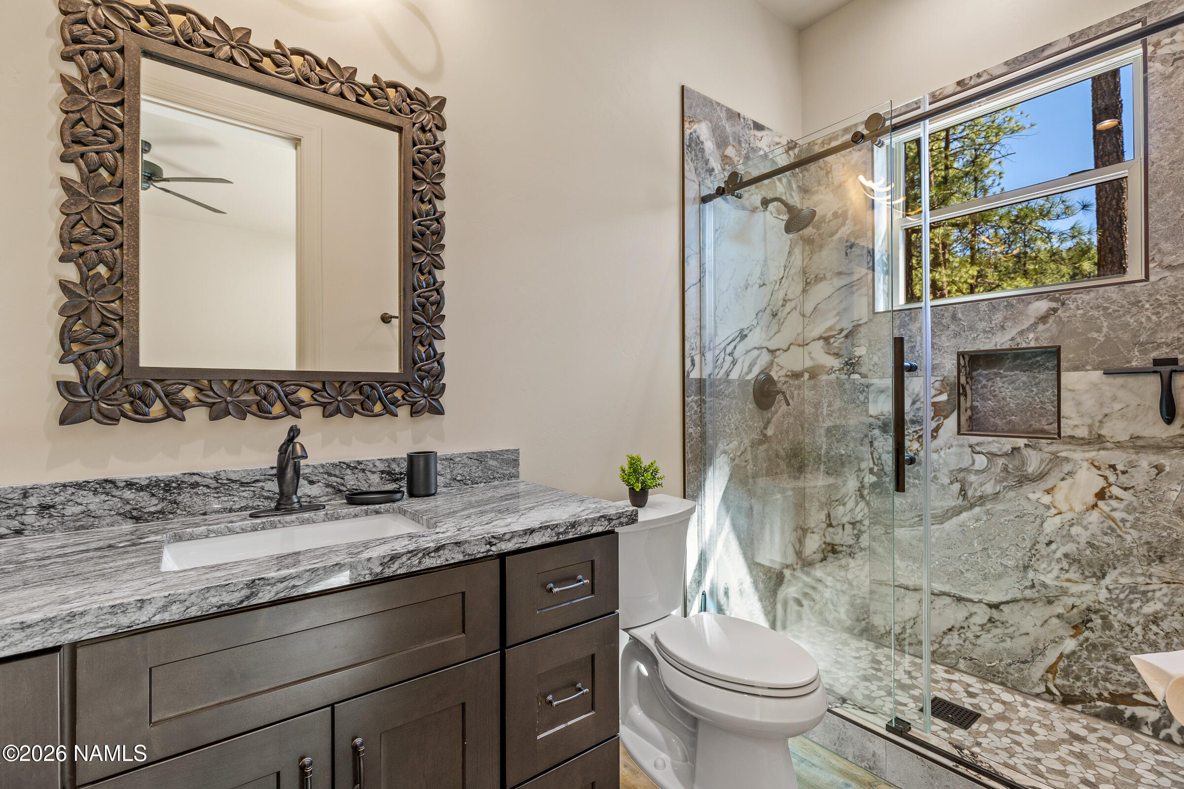 1093 Redwall Way Williams, AZ 86046 - Photo 30 of 70 a bathroom with a granite countertop sink toilet and shower