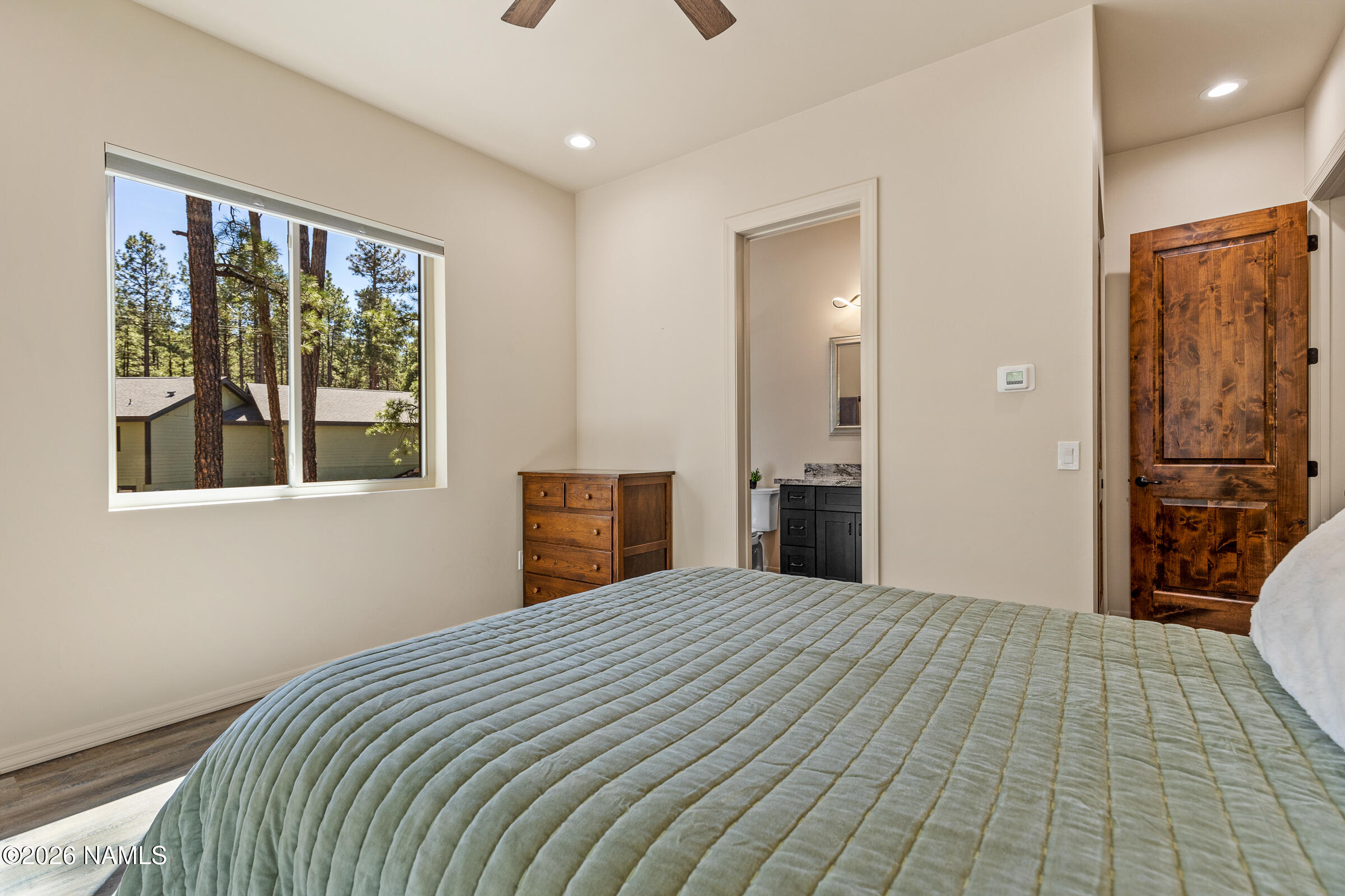 1093 Redwall Way Williams, AZ 86046 - Photo 31 of 70 a bedroom with a large bed and a large window