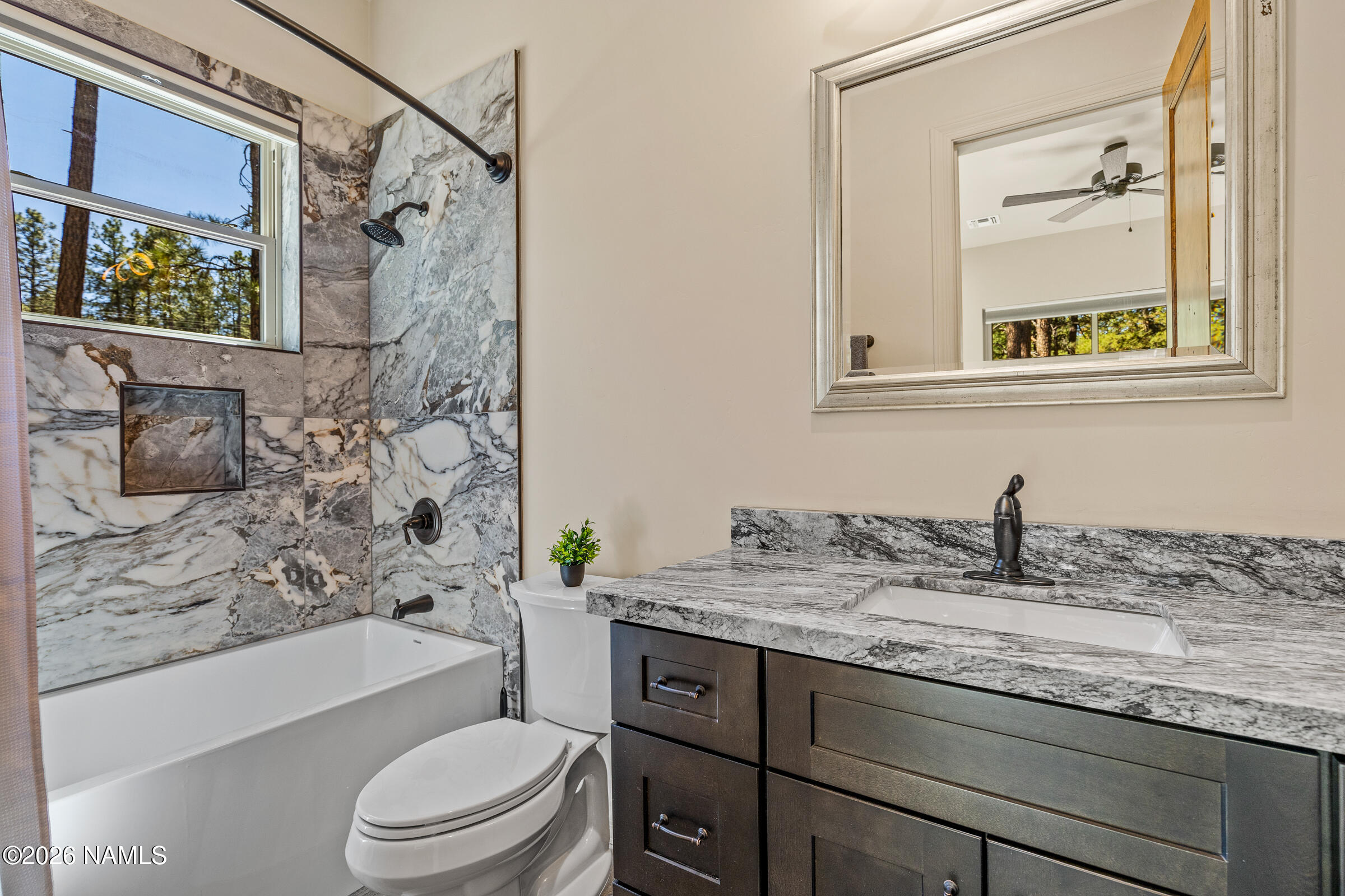 1093 Redwall Way Williams, AZ 86046 - Photo 34 of 70 a bathroom with a granite countertop sink toilet and shower