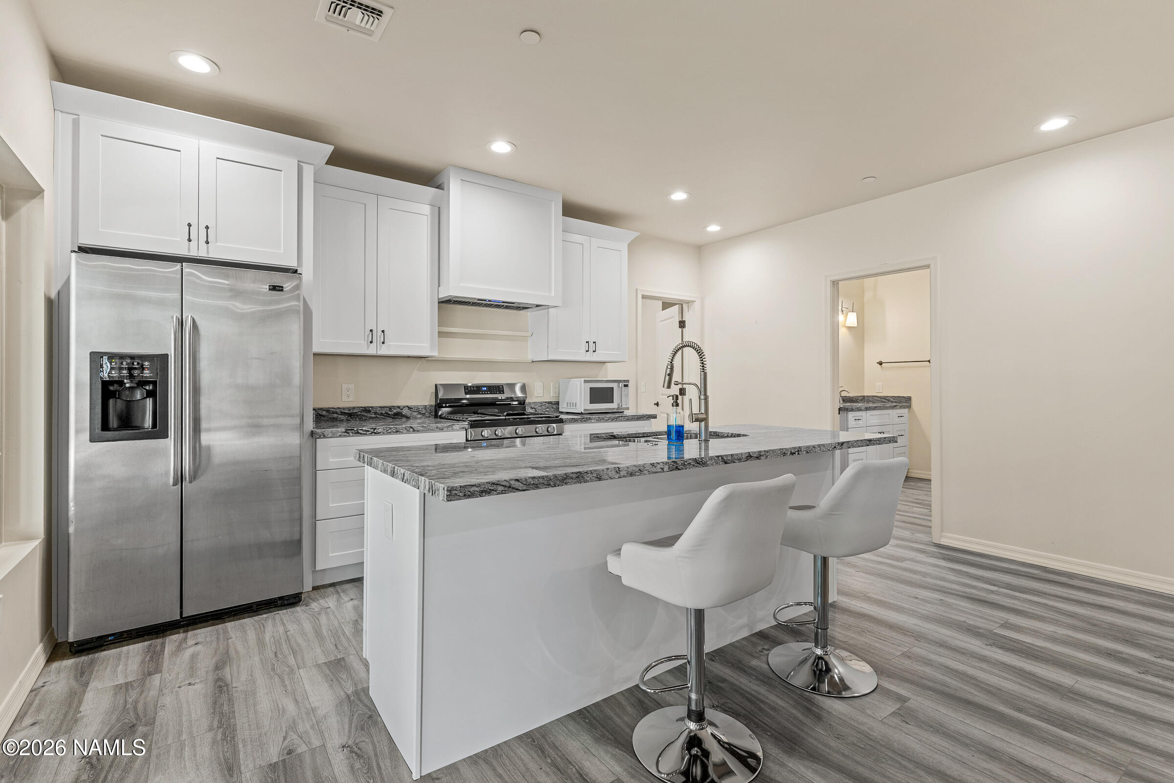 1093 Redwall Way Williams, AZ 86046 - Photo 42 of 70 a kitchen with kitchen island granite countertop a sink cabinets and stainless steel appliances