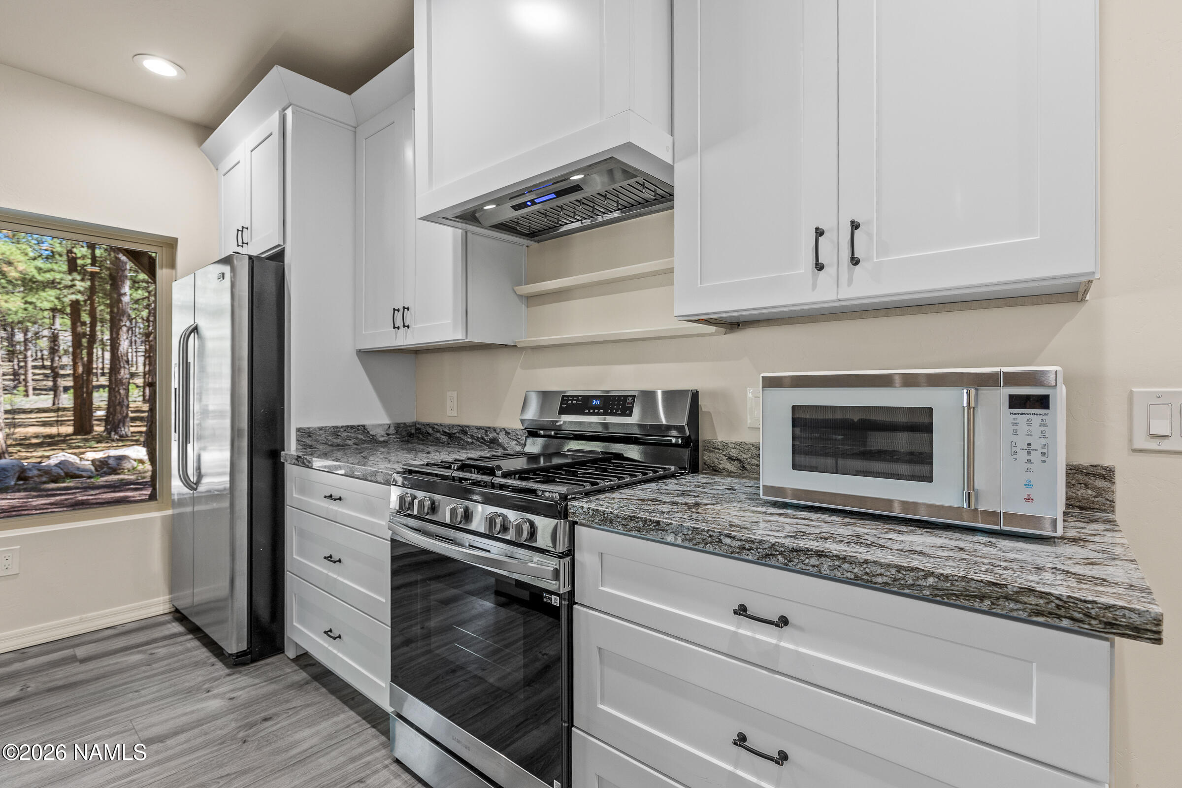 1093 Redwall Way Williams, AZ 86046 - Photo 43 of 70 a kitchen with white cabinets and appliances