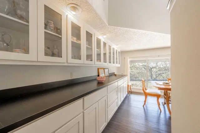a kitchen with a sink and wooden floor