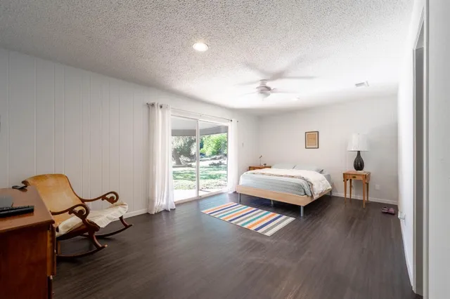 a spacious bedroom with a bed and a window