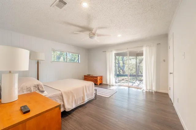 a bedroom with bed and wooden floor