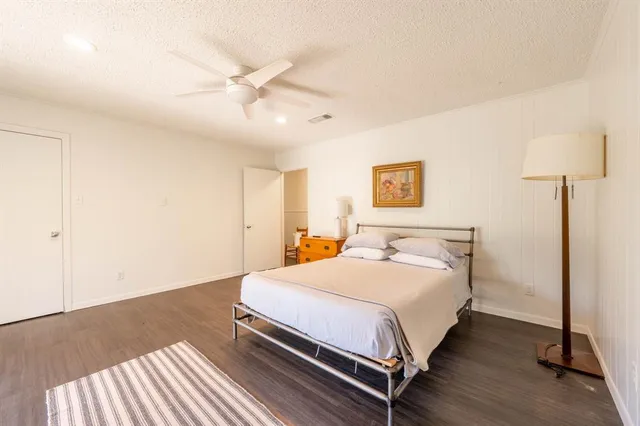 a bedroom with a bed and a lamp