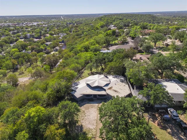 an aerial view of a house with a yard