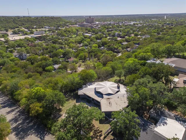 an aerial view of a house with a yard
