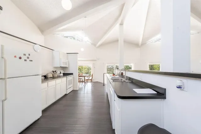 a kitchen with sink refrigerator and microwave