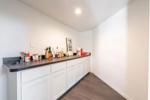a hallway with sink and mirror