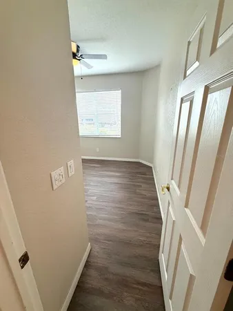 an entryway door with wooden floor