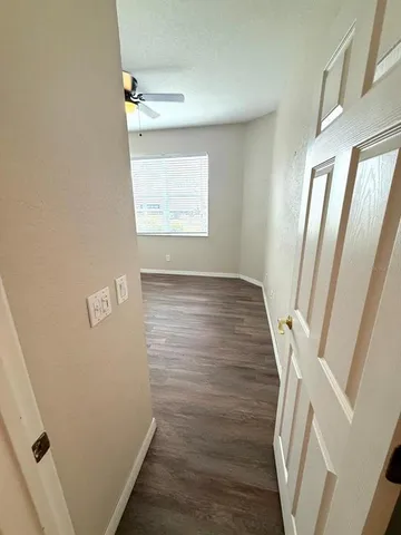 an entryway door with wooden floor