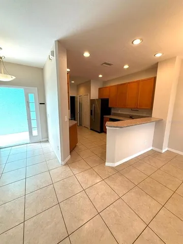 a kitchen with stainless steel appliances granite countertop a sink and a refrigerator