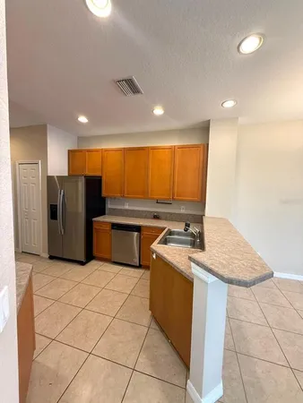 a kitchen with stainless steel appliances granite countertop a sink refrigerator and microwave