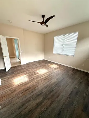 a view of a livingroom with a ceiling fan and window