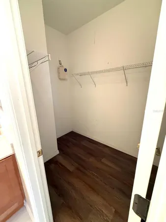 a view of a yard with wooden fence and a large tree