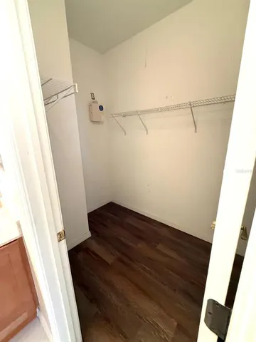 a view of a yard with wooden fence and a large tree