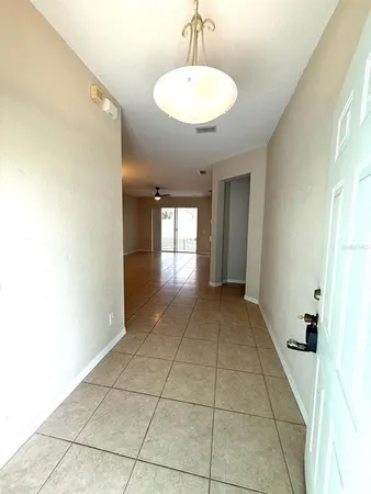 a view of empty room with a sink and a mirror
