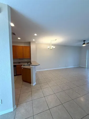 a kitchen with a sink a counter top space and stainless steel appliances
