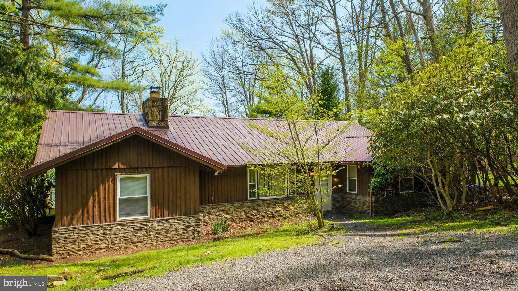 2187 State Park Road Swanton, MD 21561 - Photo 7 of 29 a front view of a house with garden