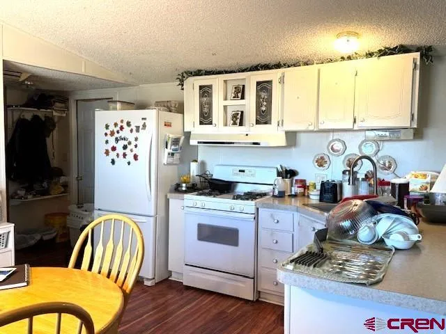 a kitchen that has a table and chairs in it