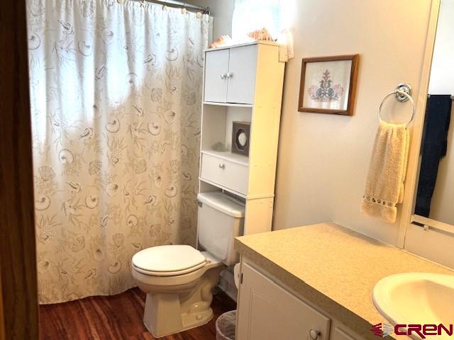 11290 Highway 145 Cortez, CO 81321 - Photo 20 of 27 a bathroom with a toilet sink and mirror