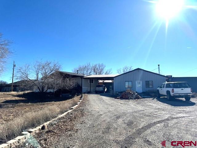 11290 Highway 145 Cortez, CO 81321 - Photo 2 of 27 a view of a house with a yard and roof