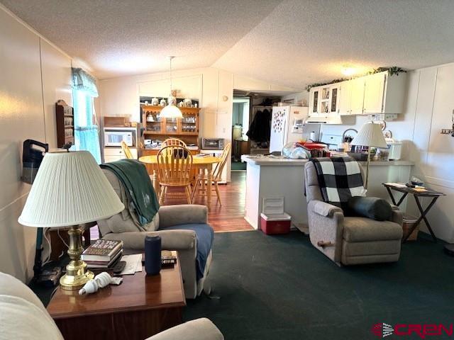 11290 Highway 145 Cortez, CO 81321 - Photo 10 of 27 a living room with furniture and a chandelier