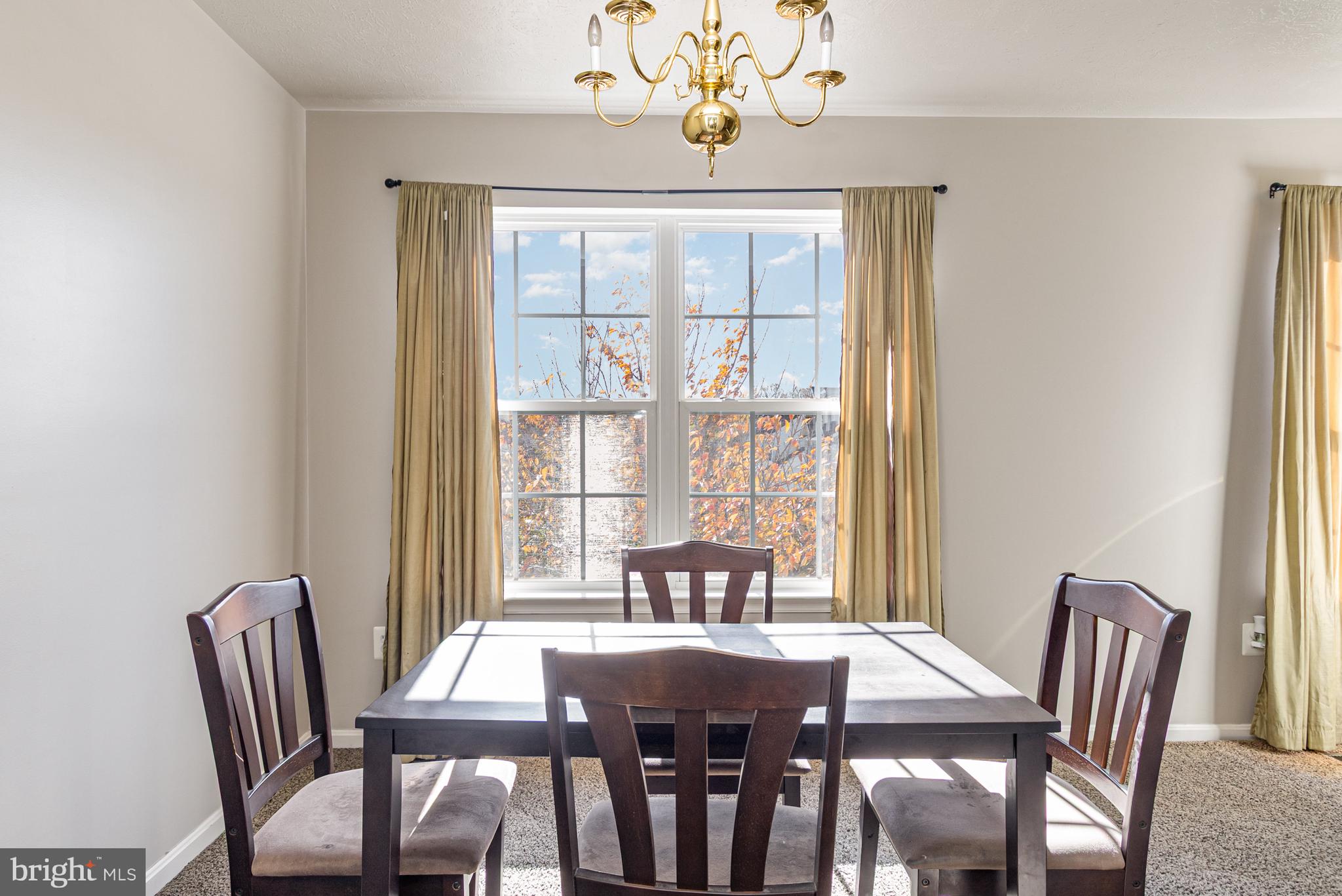 124 Maple Leaf Drive Rising Sun, MD 21911 - Photo 16 of 46 a view of a dining room with furniture a chandelier and wooden floor
