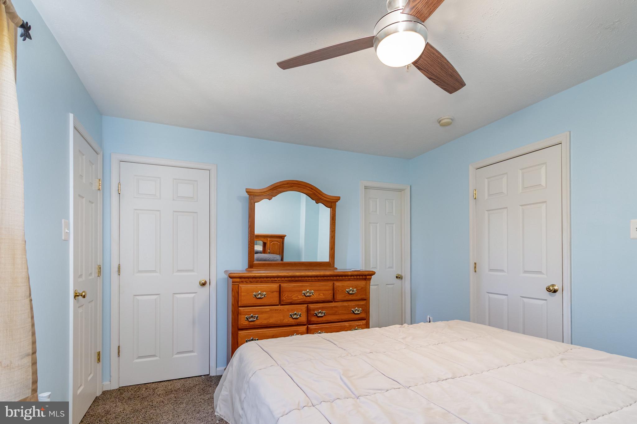 124 Maple Leaf Drive Rising Sun, MD 21911 - Photo 25 of 46 a bedroom with a bed and a chandelier