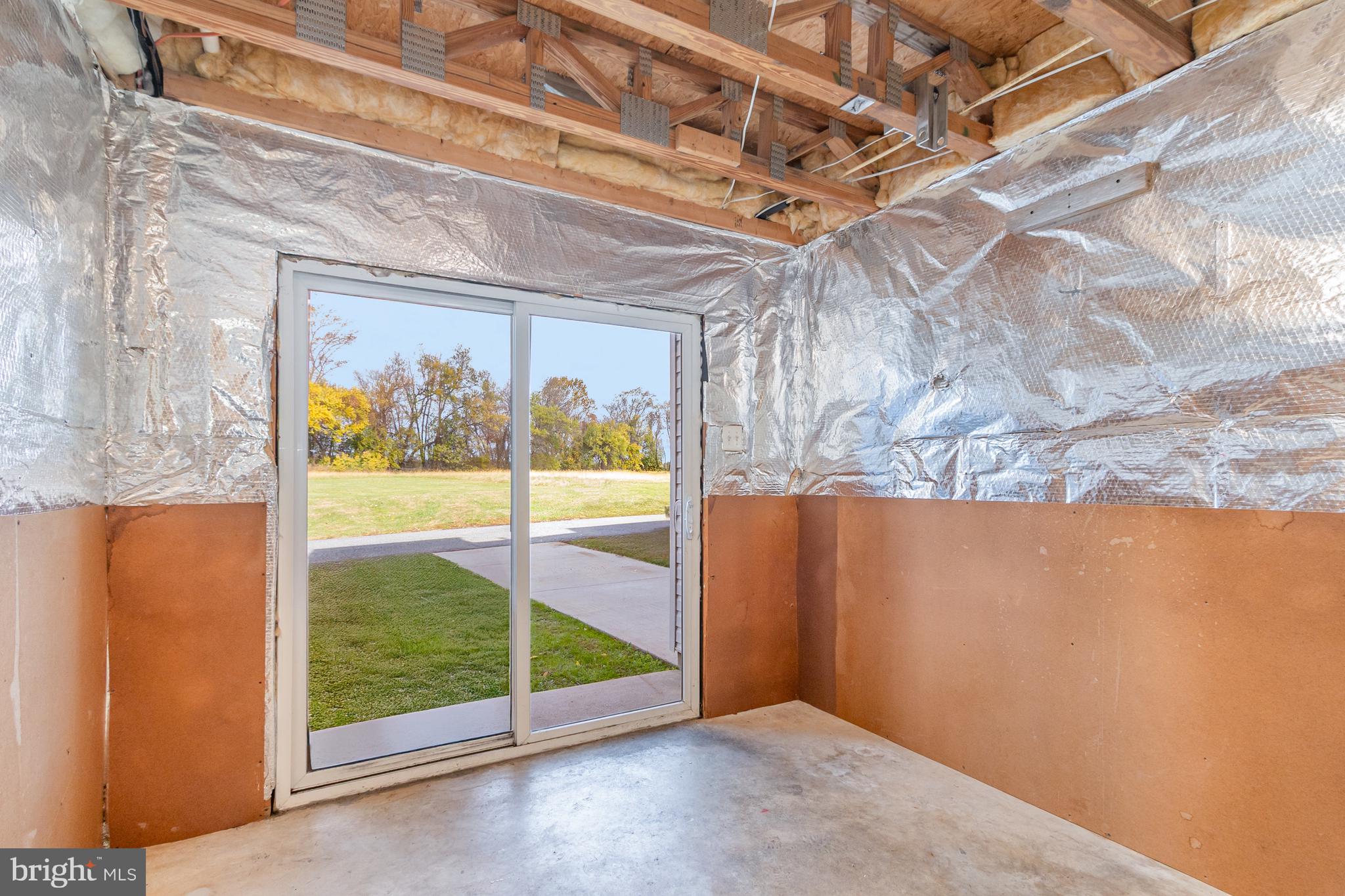 124 Maple Leaf Drive Rising Sun, MD 21911 - Photo 35 of 46 a view of an empty room with a floor to ceiling window and wooden floor