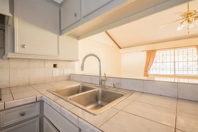 a kitchen with a sink cabinets and window
