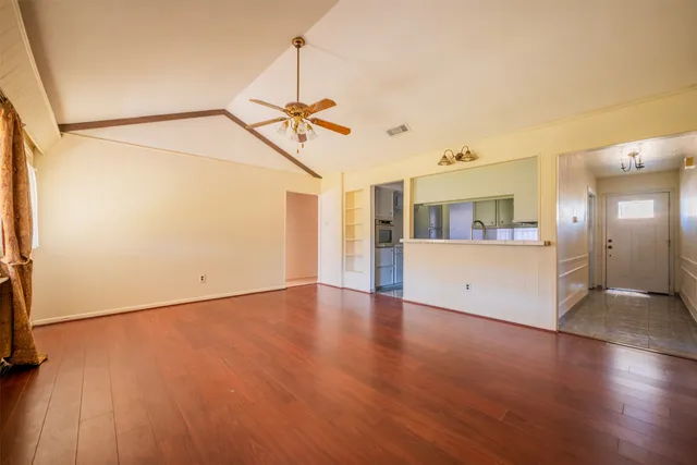 wooden floor in an empty room with a window