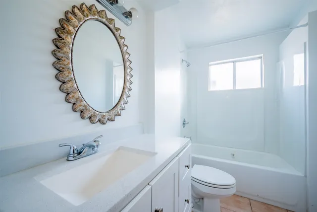 a white bath tub sitting next to a toilet